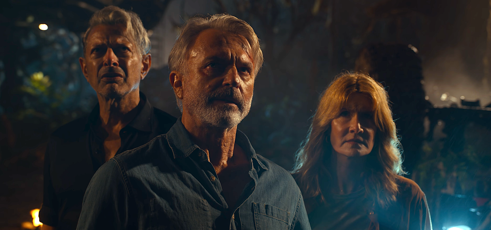 Jeff Goldblum, Sam Neill, and Laura Dern stand together in Jurassic World: Dominion
