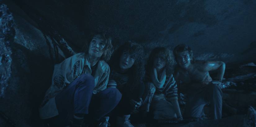 Robin, Eddie, Nancy, and Steve, crouching in the Upside Down