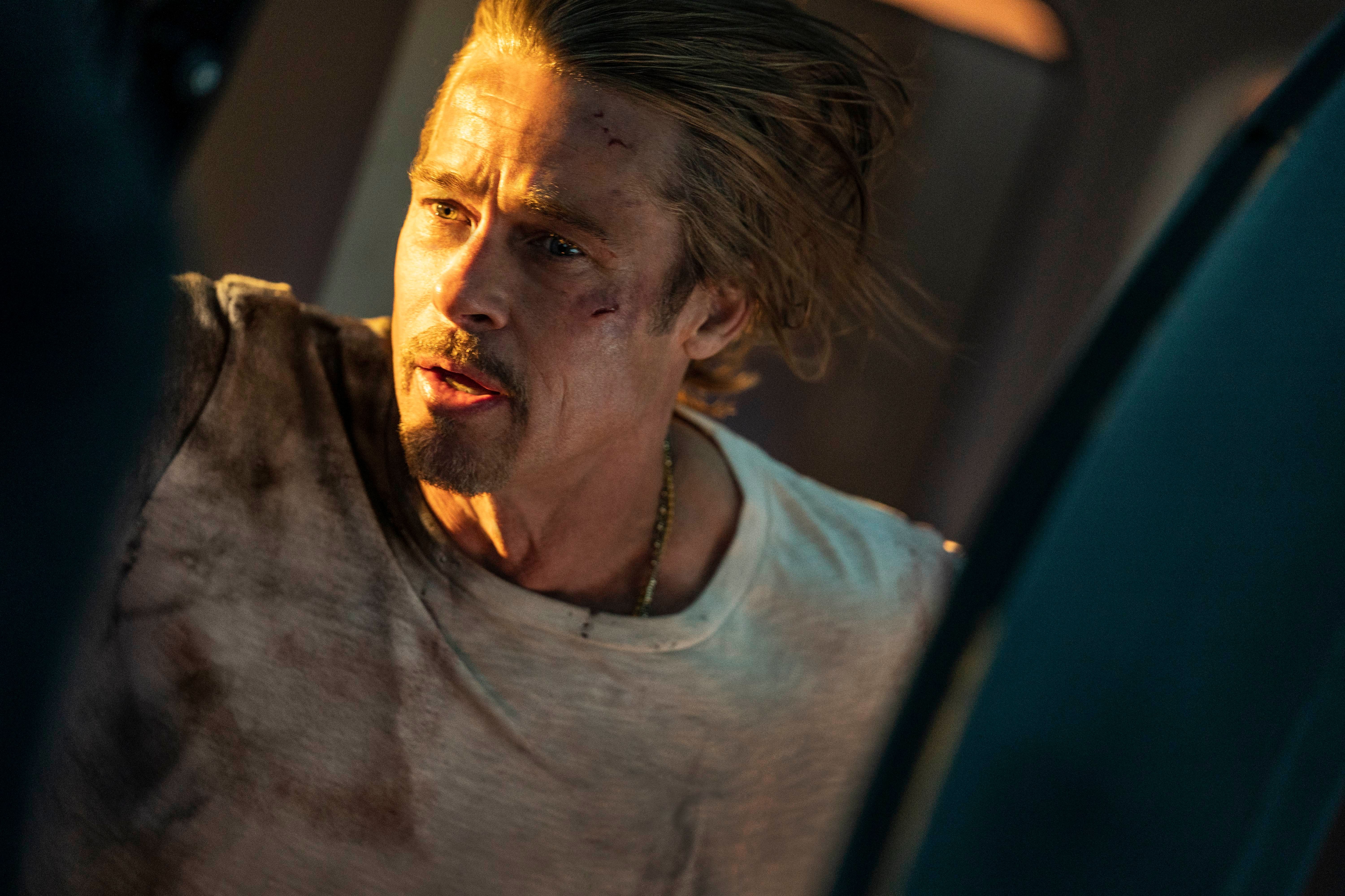 Ladybug (Brad Pitt) looking out a train door in Bullet Train