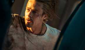 Ladybug (Brad Pitt) looking out a train door in Bullet Train