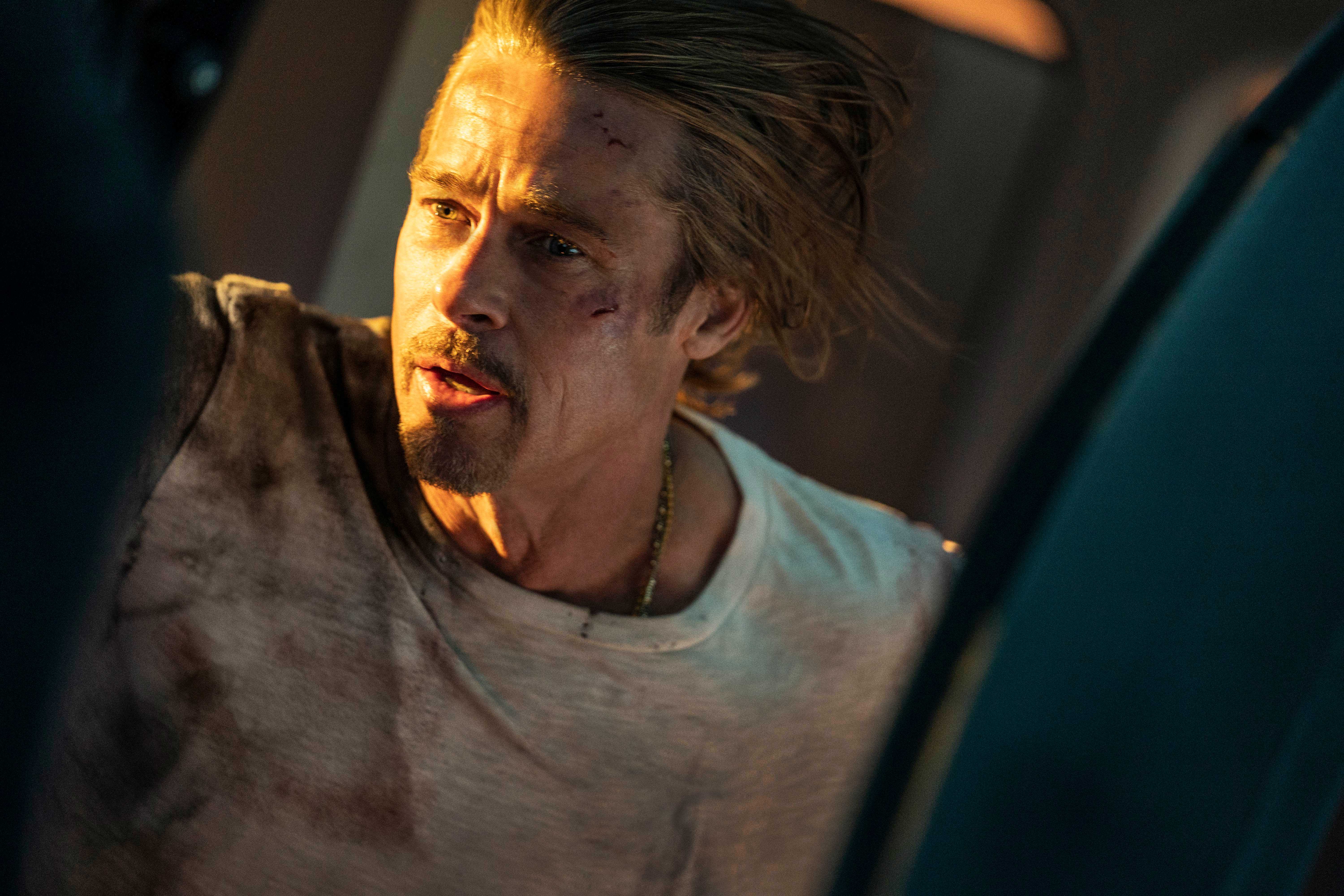 Ladybug (Brad Pitt) looking out a train door in Bullet Train