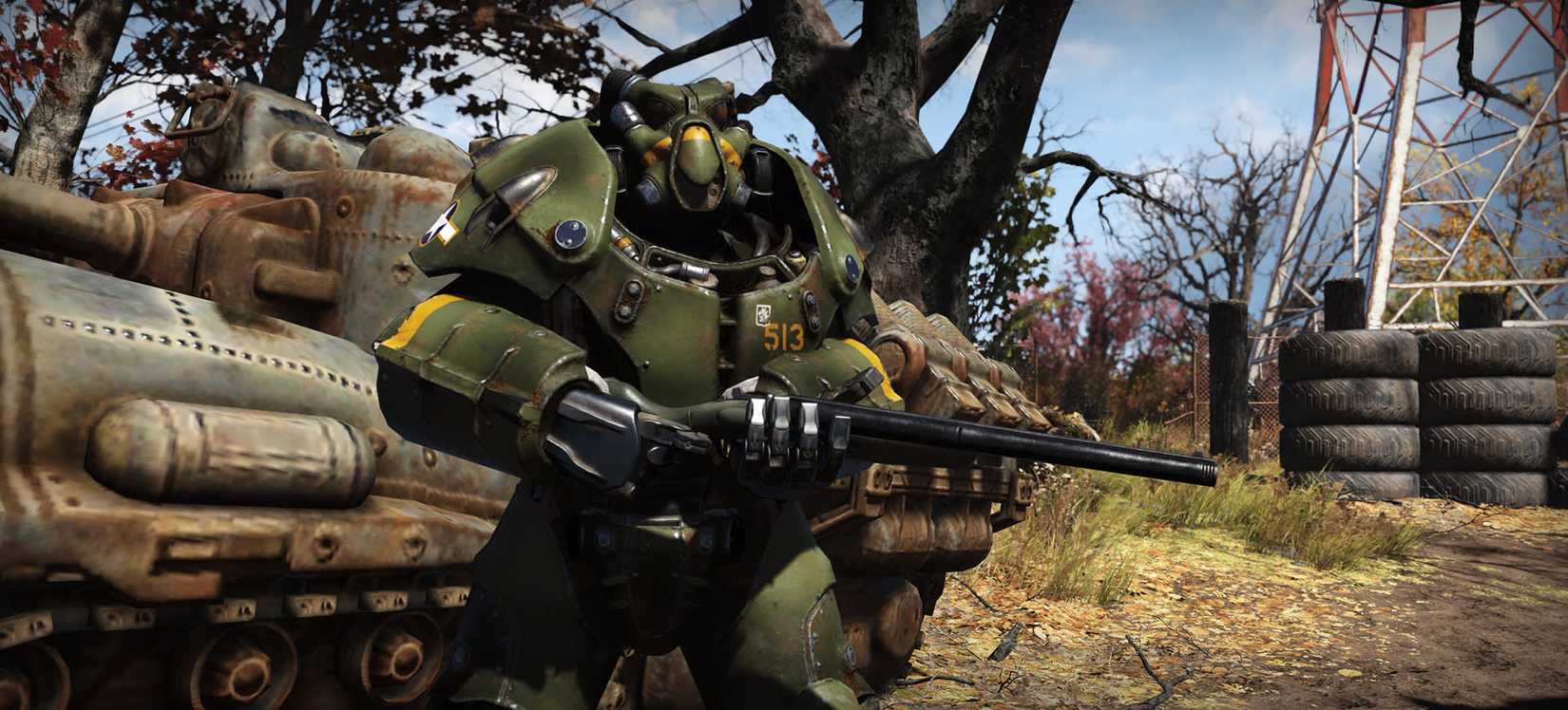 Fallout 76 - A player in Enclave-style power armor painted dark green poses with an intimidating weapon in his hands.