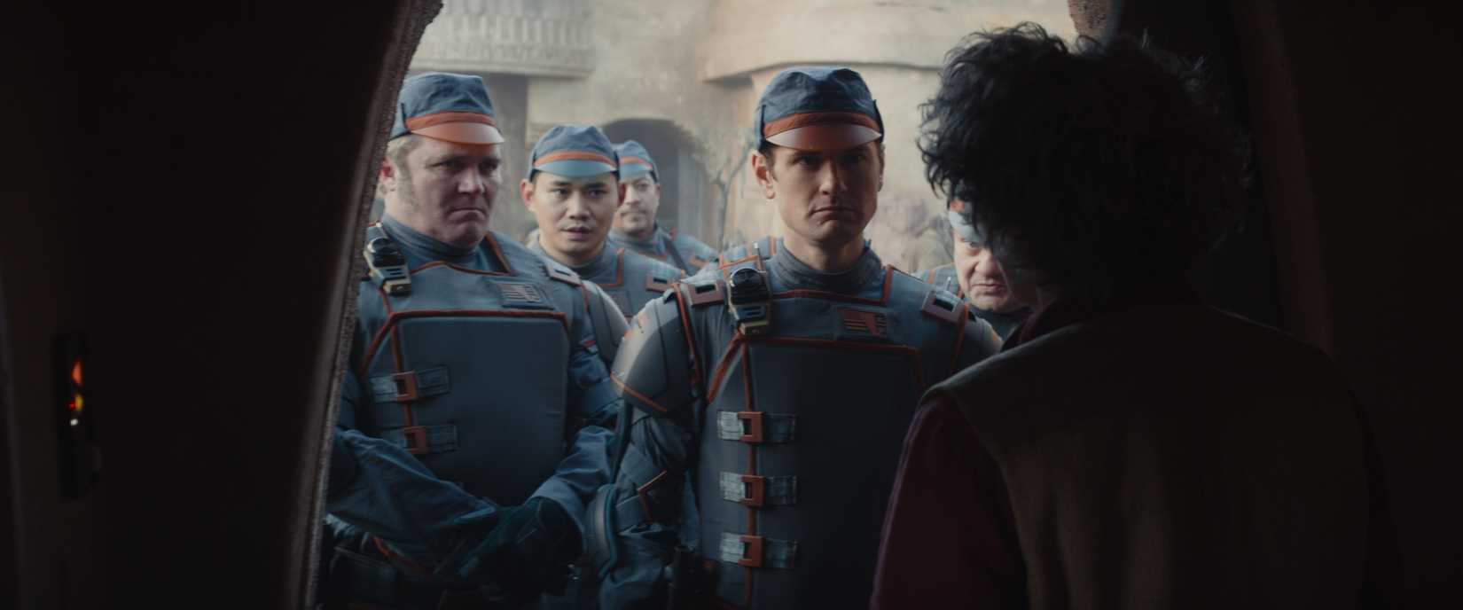 Syril Kam and his fellow officers standing in the doorway of Maarva, looking imposing as she’s silhouetted against them