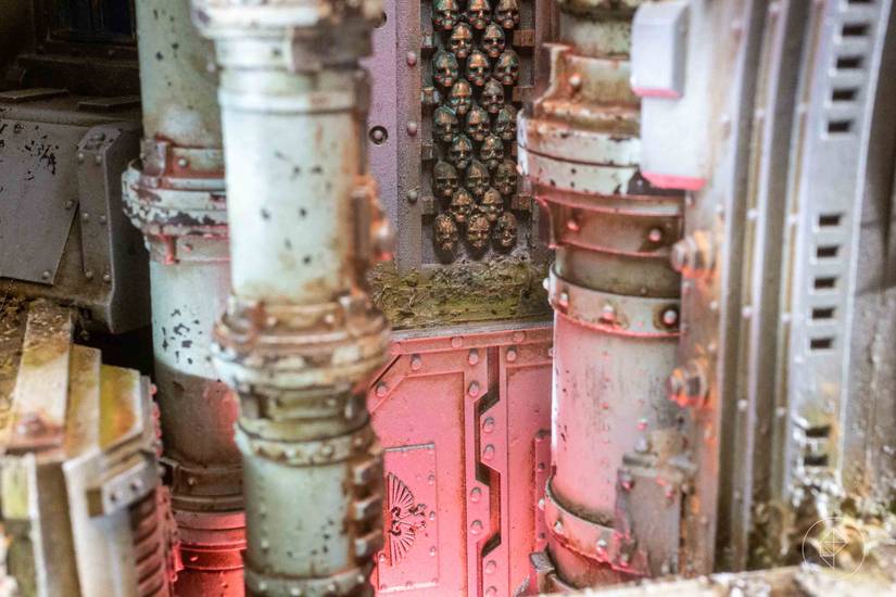 Details of a gothic spacecraft. The camera zooms in past destroyed pipes, over an ominous red glow, to the bones of the room itself — which is built out of skulls.