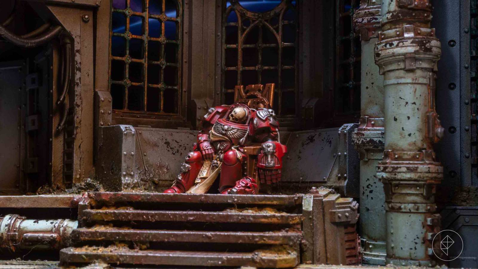 A Blood Angels Terminator Space Marine, his head reduced to a blanched skull but his red armor resplendent, sits upon a gilded throne. Around him the interior of a regal command room in a Gothic spaceship lies in filthy ruins. Behind him a moon arcs over the horizon of a distant planet.