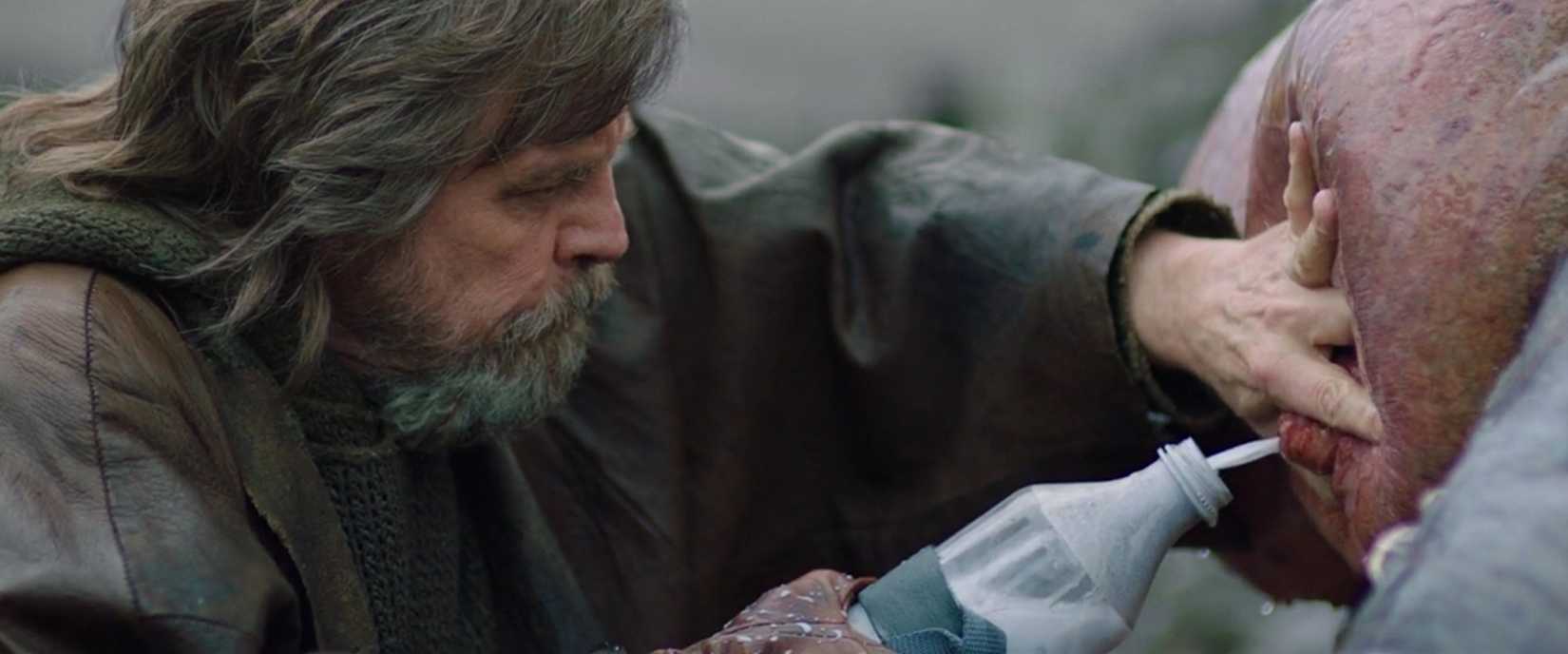 Luke Skywalker presses an alien udder to obtain green milk in The Last Jedi
