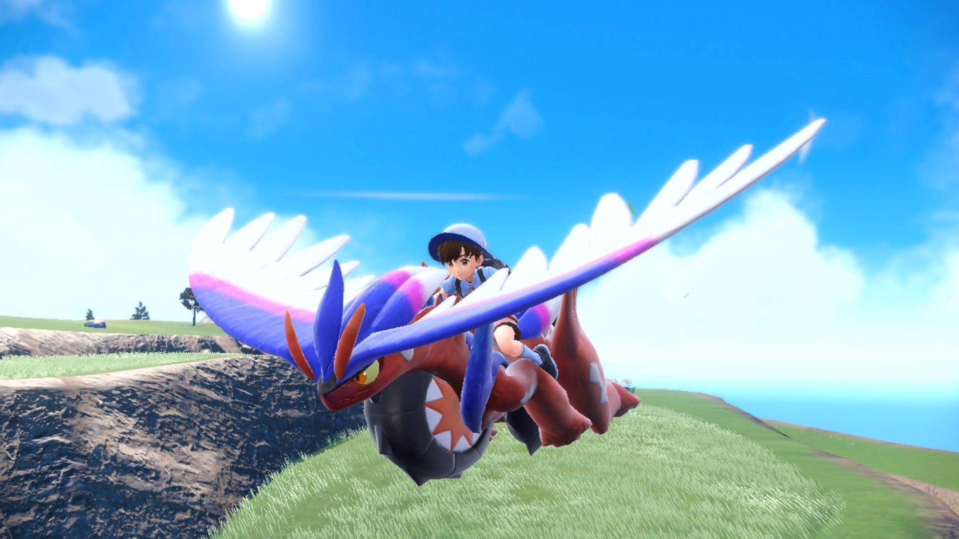 An image of a Pokémon trainer gliding on a Koraidon in Pokémon Scarlet.