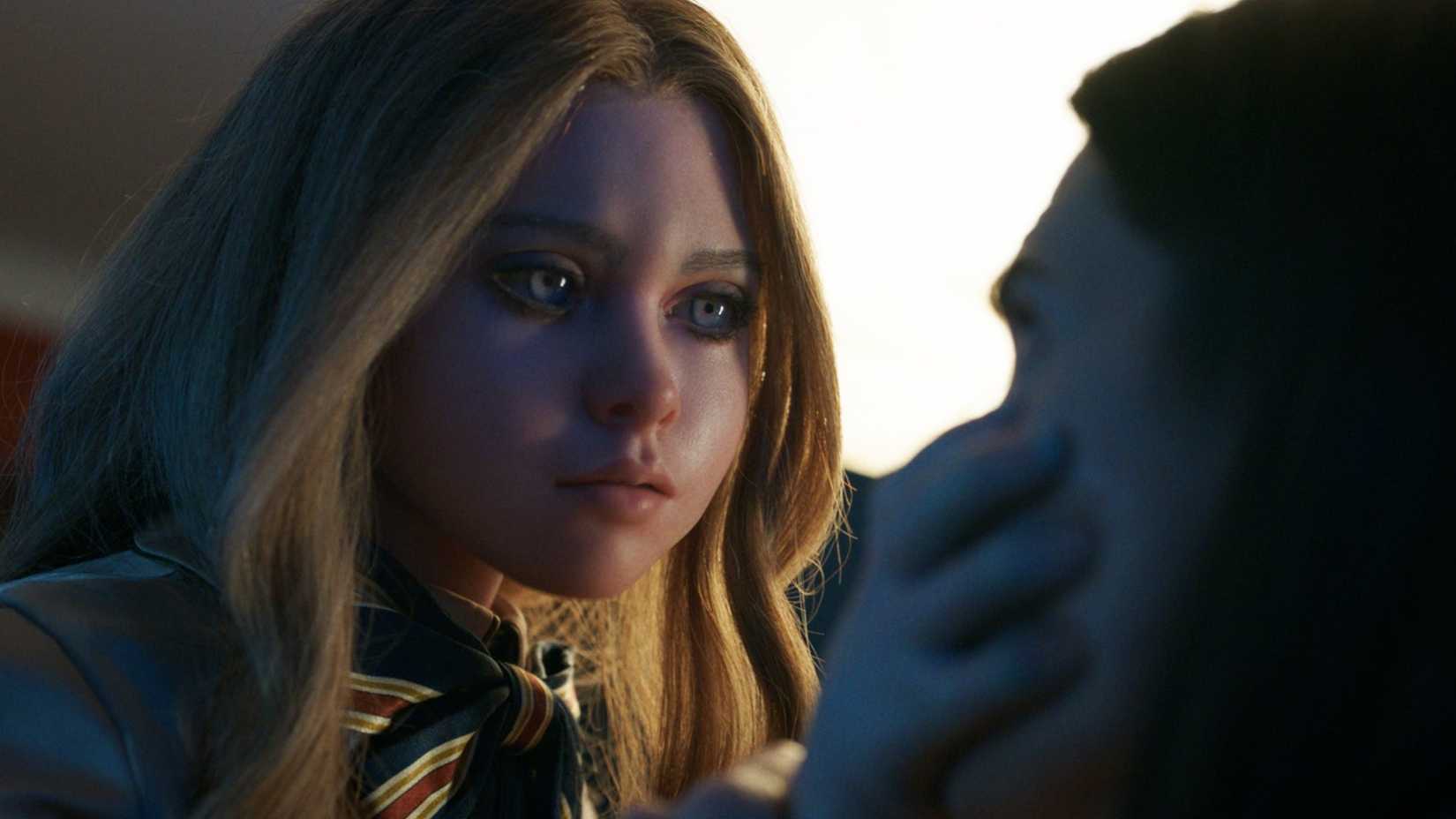 The killer AI doll M3GAN (Amie Donald) grabs her creator Gemma (Allison Williams) by the face in M3GAN