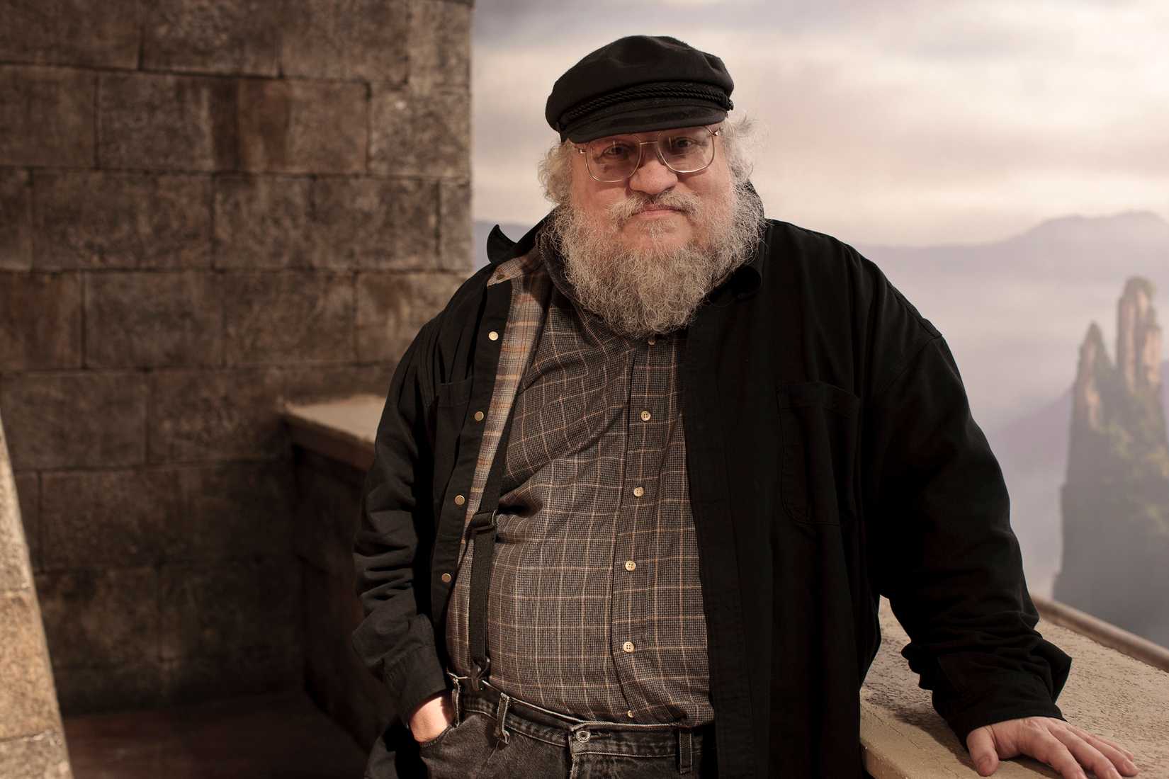 George R.R. Martin standing in a castle for a Game of Thrones promo shoot