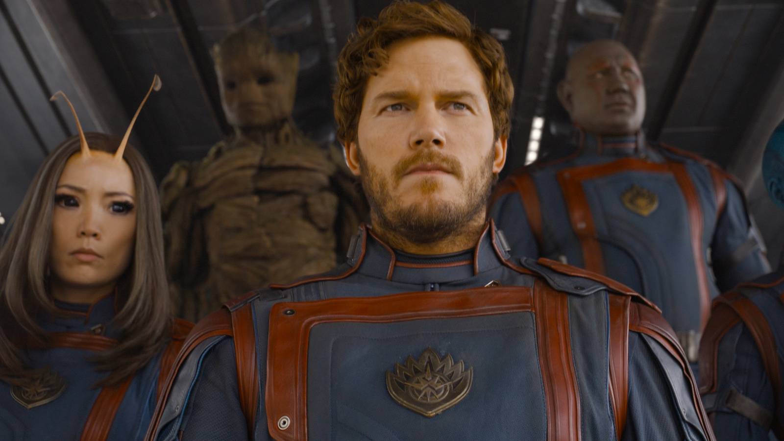 (L-R): Pom Klementieff as Mantis, Groot (voiced by Vin Diesel), Chris Pratt as Peter Quill/Star-Lord, Dave Bautista as Drax, Karen Gillan as Nebula in Marvel Studios’ Guardians of the Galaxy Vol. 3. It’s a shot of them from the chests up as they walk down a ship’s gangplank in their Guardians uniforms. 