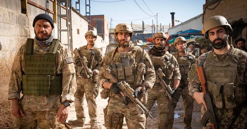 A group of soldiers in desert camouflage, bulletproof vests, and holding rifles in Guy Ritchie’s The Covenant.