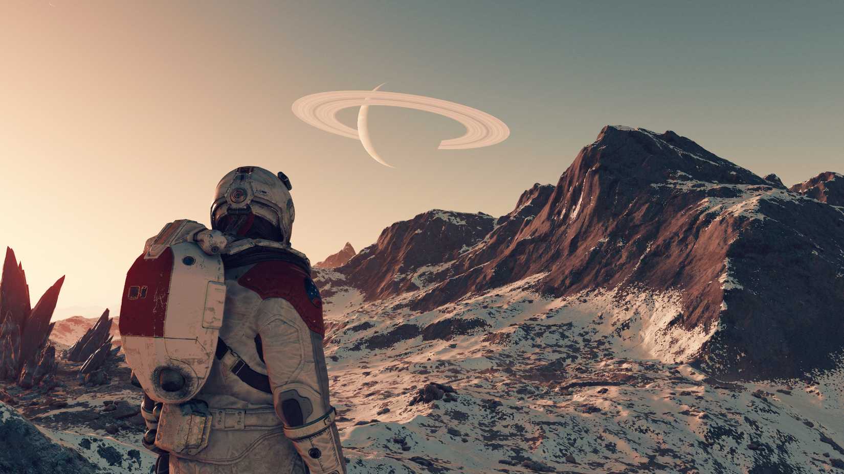 A space explorer on the surface of a snowy moon, with a ringed planet in the sky, in Starfield