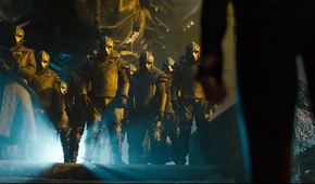 The Klingons greeting Uhura (Zoe Saldana) by standing and looking imposing with helmets on in a still from Star Trek into Darkness