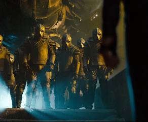 The Klingons greeting Uhura (Zoe Saldana) by standing and looking imposing with helmets on in a still from Star Trek into Darkness
