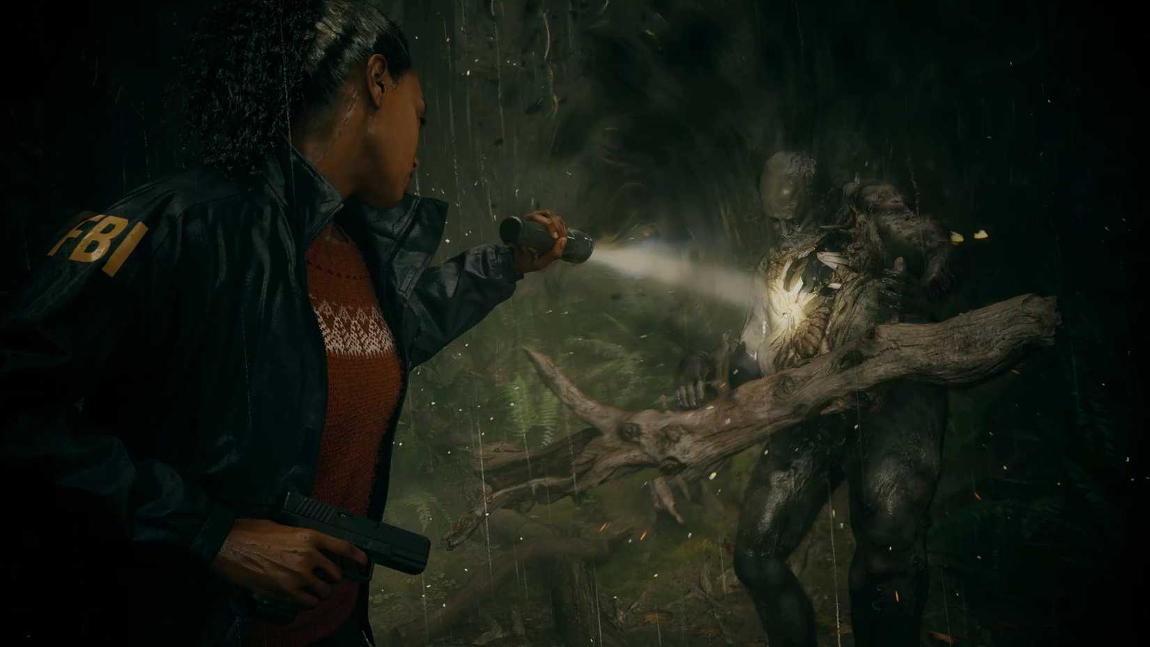 FBI agent Saga Anderson aims her flashlight at a monster in a forest setting in Alan Wake 2