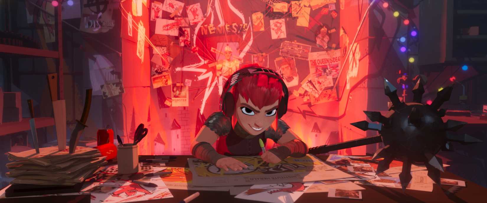 A red-haired animated girl with a mischievous smile on her face wearing headphones hunches over a desk while drawing on a piece of paper in Nimona.