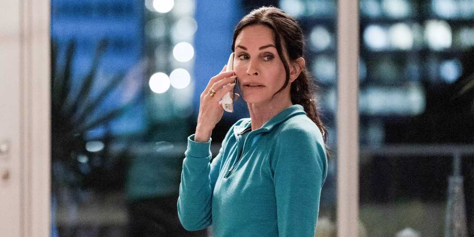 Gale Weathers (Courteney Cox) looking concerned while on a phone call in Scream VI