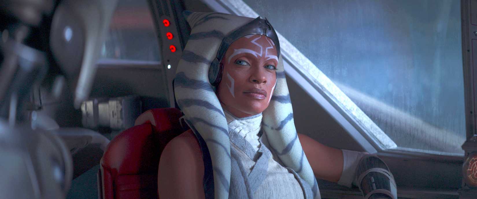 Ahsoka (Rosario Dawson) sits and looks at something with a side eye