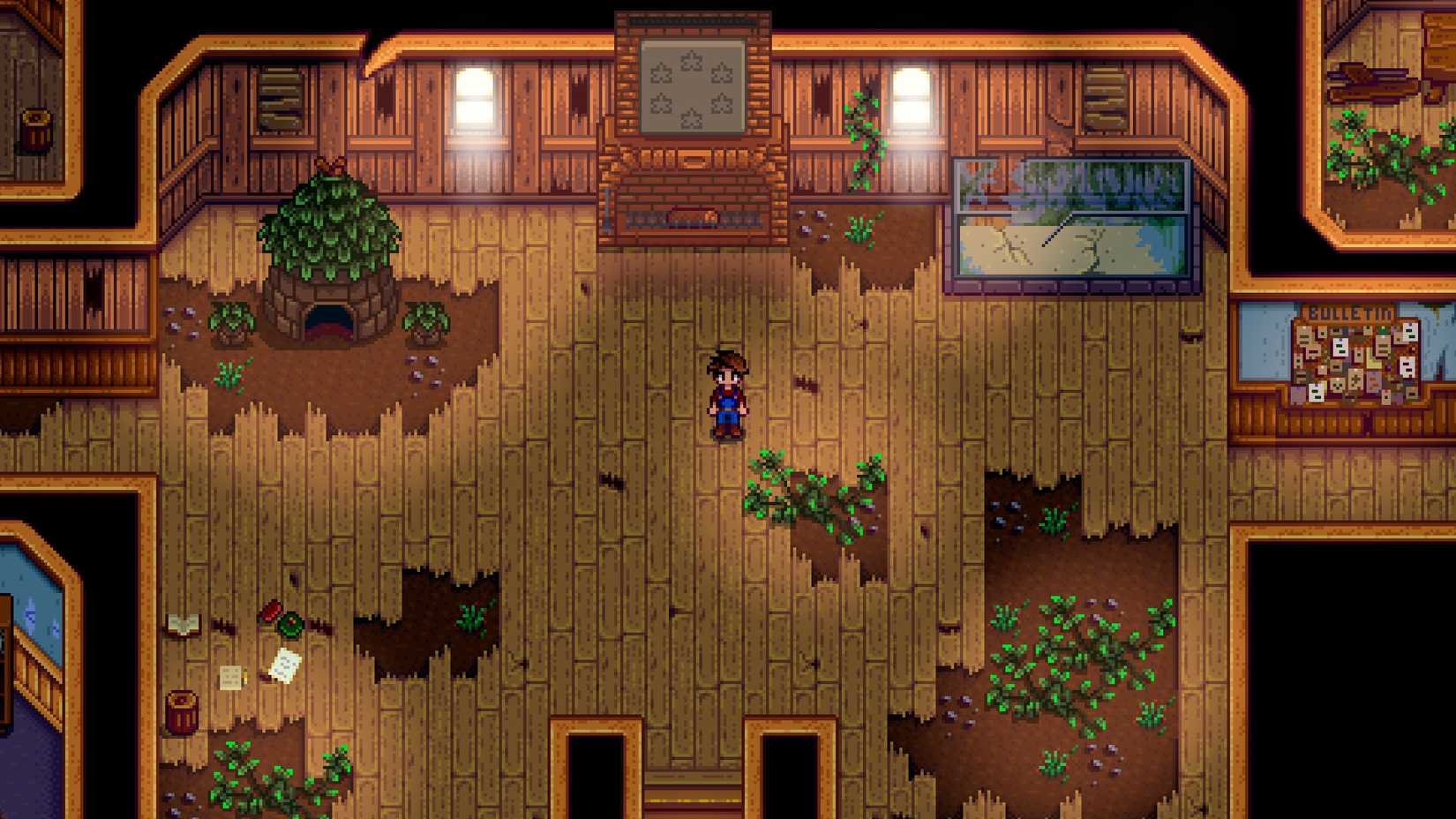 An image of a Stardew Valley character standing alone in a room. It’s a dilapidated community center.