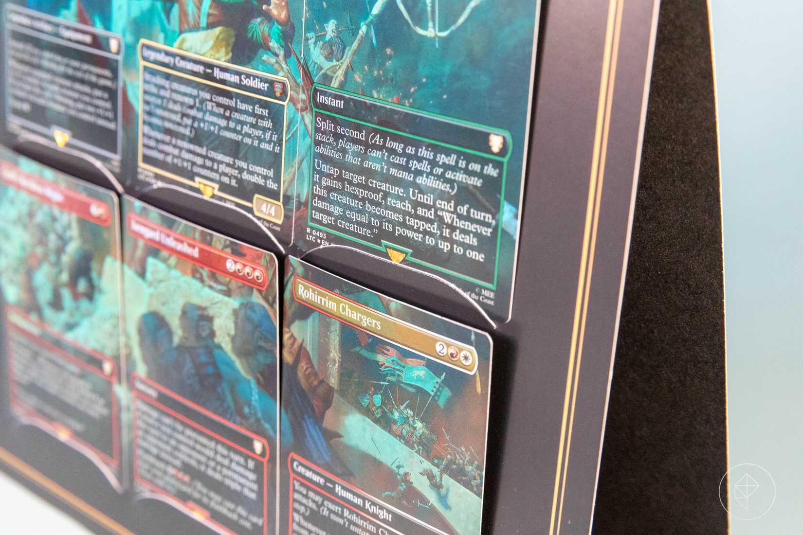 A close-up of a paper device used for holding Magic cards. A Scene Box.