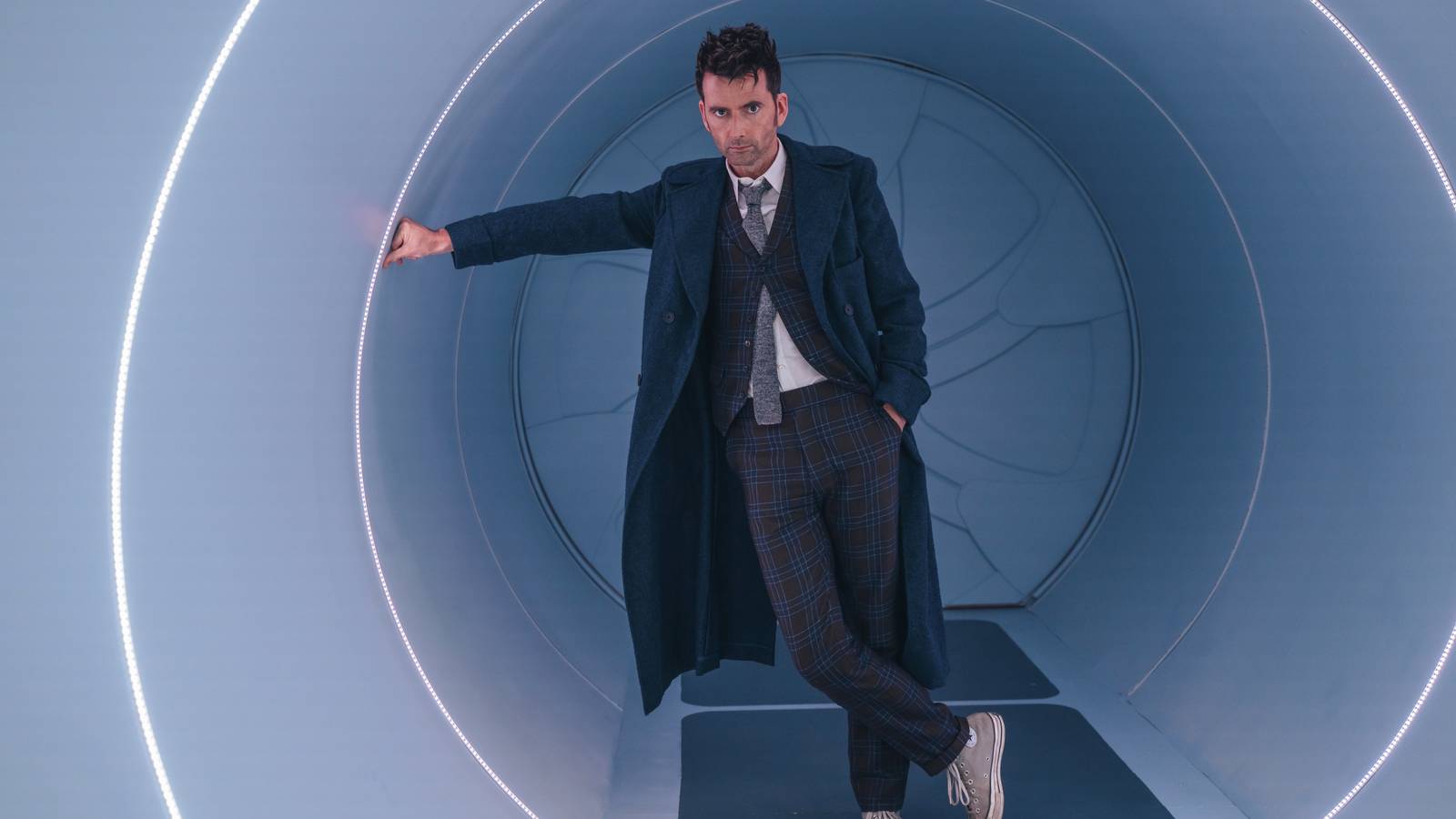 David Tennant as The Fourteenth Doctor, leaning against the entrance of his TARDIS in the special episode The Star Beast