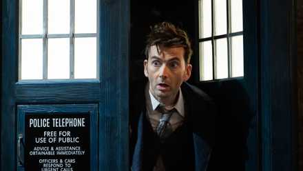 David Tennant’s Fourteenth Doctor peeks out of the blue police box doors of the TARDIS in one of the Doctor Who 60th anniversary specials