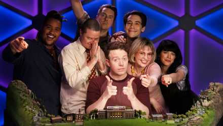 The cast of Dimension 20: Fantasy High - Junior Year looks excited to see you in a press photo. They’re inside a blue and purple dome, with a beautiful set of high-school-shaped terrain in the foreground.