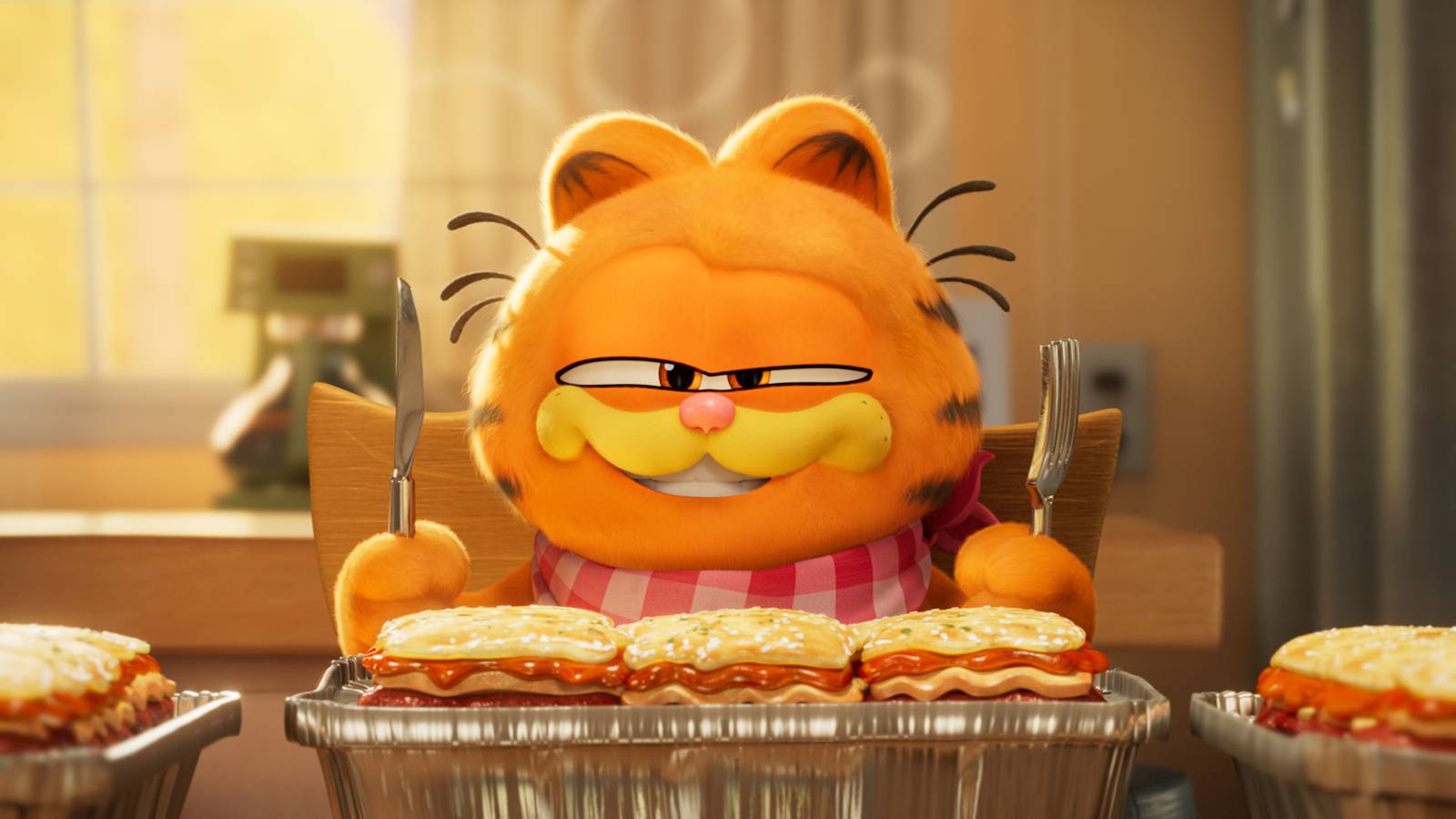 An animated Garfield, wearing a bib and holding a fork and knife, is ready to absolutely chow down on some lasagna in The Garfield Movie.