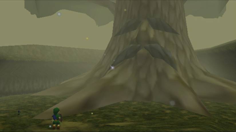 A child Link stands before the Great Deku Tree, a giant tree with a sad face, in Zelda: Ocarina of Time