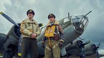 Callum Turner and Austin Butler stand befor Our Baby, one of the many il-fated Fortresses that co-star in Masters of the Air. It’s bristling with guns.