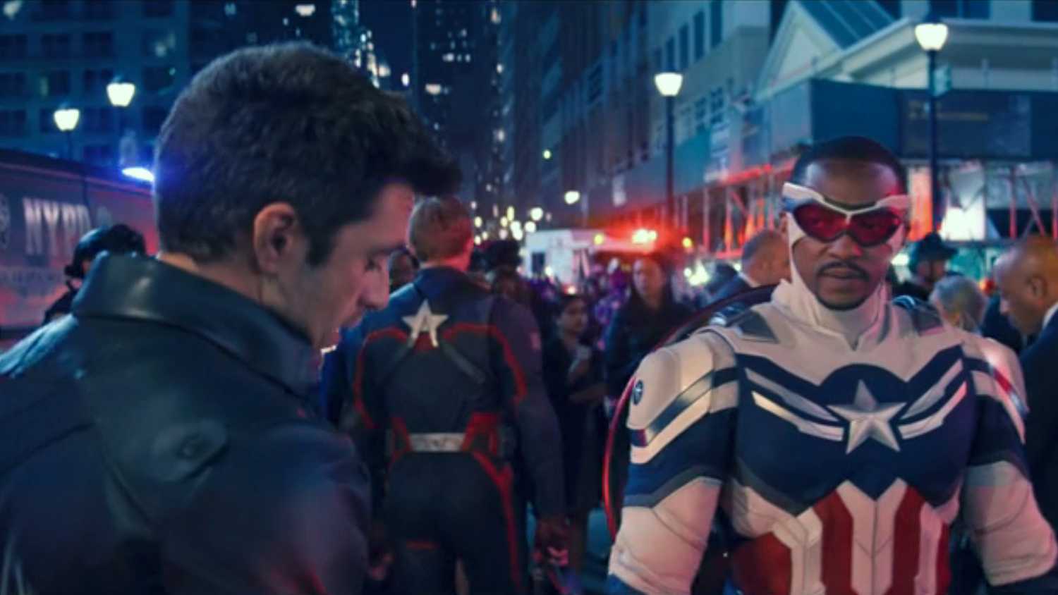 Bucky (Sebastian Stan) and Captain America/Falcon (Anthony Mackie) speak in a crowded NYC city street in a shot from The Falcon and The Winter Soldier