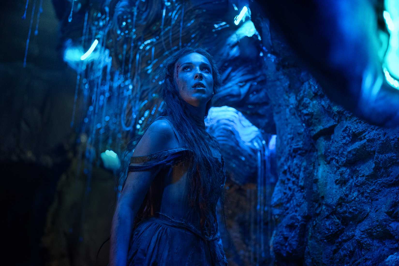 Millie Bobby Brown in a translucent blue cavern in Damsel