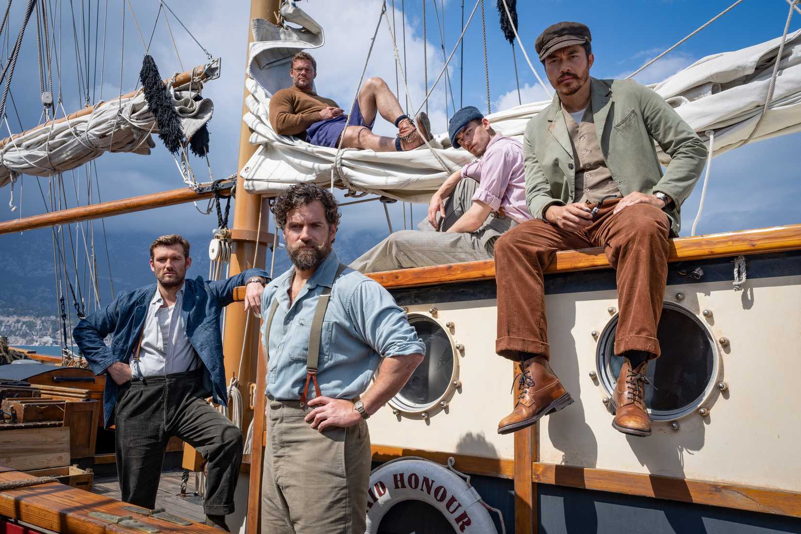 Henry Cavill and the cast of The Ministry of Ungentlemanly Warfare stand around looking manly on a boat