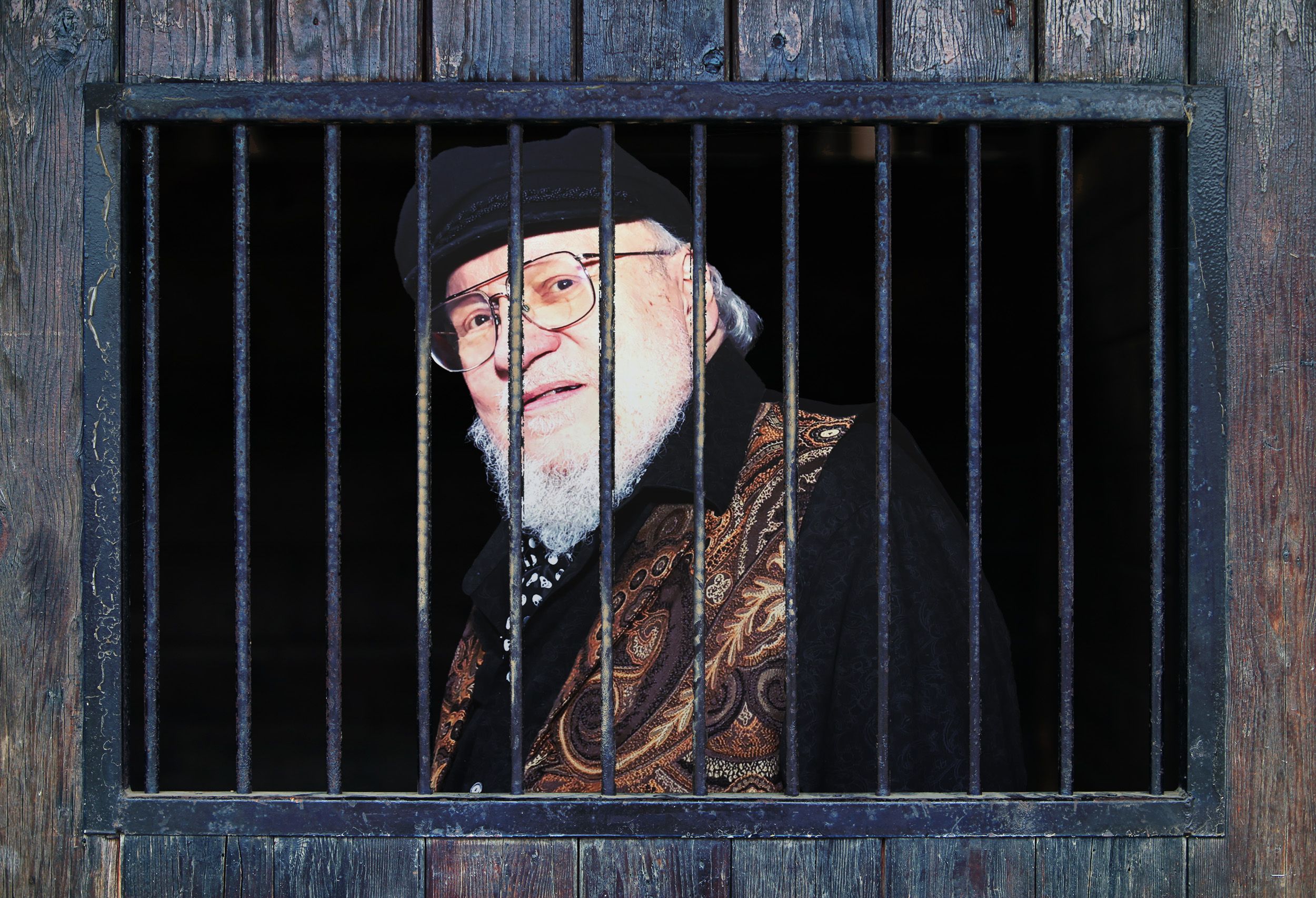 A graphic depicting George R.R. Martin behind bars