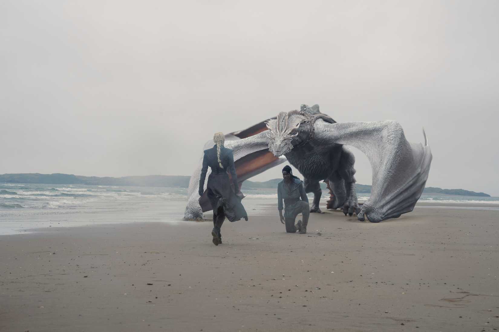 Seasmoke behind a kneeling Addam of Hull, as Rhaenyra walks across the beach to them