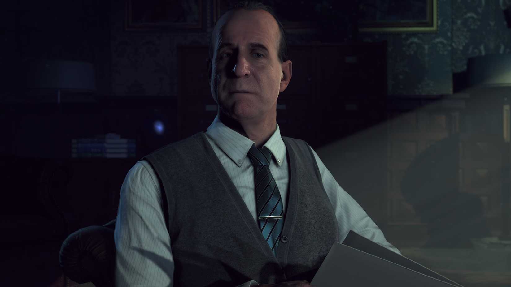 Dr. Alan Hill staring towards the camera in Until Dawn. He’s wearing a vest and tie.