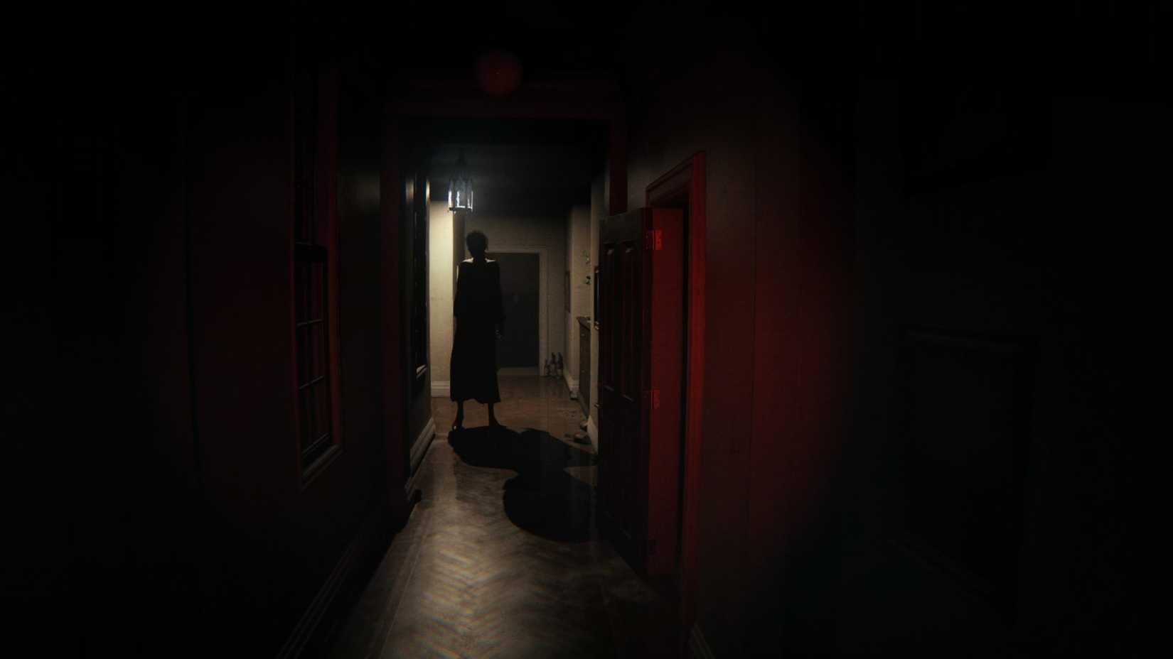 P.T.’s ghost, Lisa, stands in a dark hallway