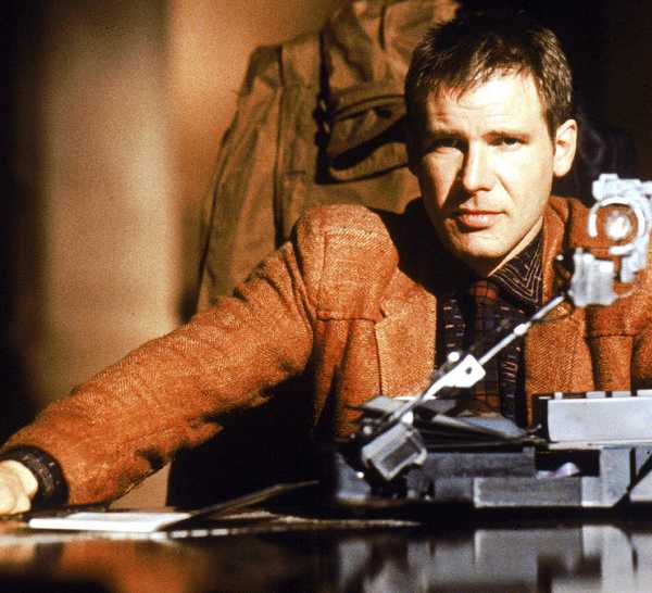 Harrison Ford sitting at a table in Blade Runner