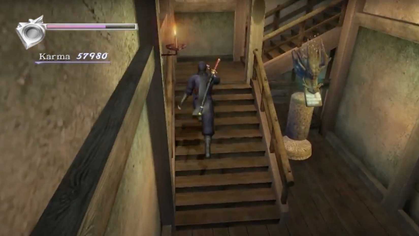 An in-game screenshot from Ninja Gaiden Black, showing Ryu climbing interior stairs